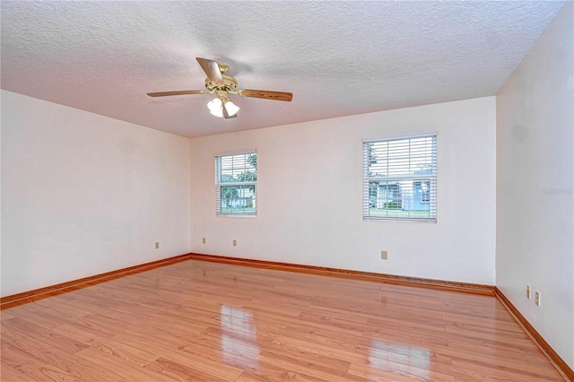 spare room featuring a textured ceiling, light hardwood / wood-style flooring, and ceiling fan