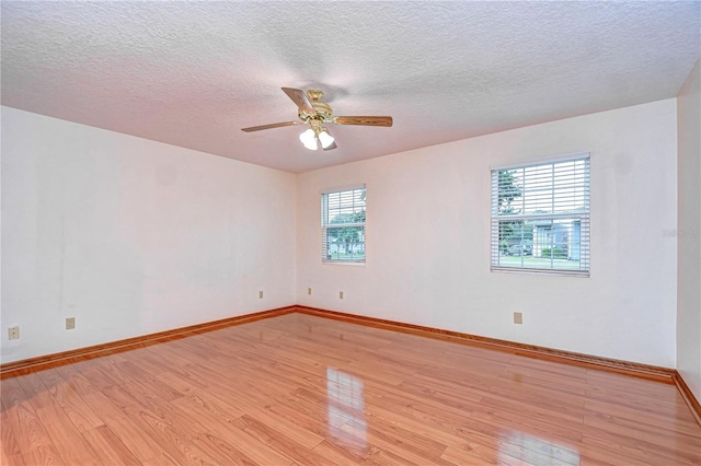 spare room featuring ceiling fan, a textured ceiling, and light hardwood / wood-style floors