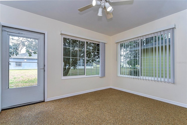 interior space with carpet floors and ceiling fan