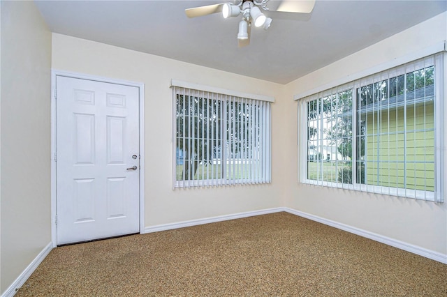 carpeted empty room featuring ceiling fan