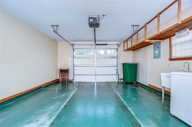 garage with a garage door opener, washer / dryer, and electric panel