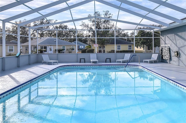 view of swimming pool featuring a lanai and a patio area