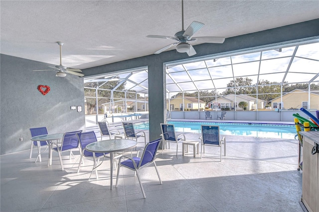 view of patio featuring glass enclosure