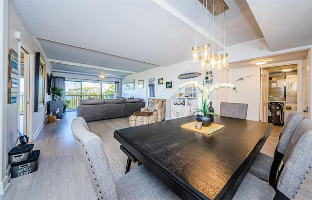 dining area with hardwood / wood-style flooring, ceiling fan, and beam ceiling