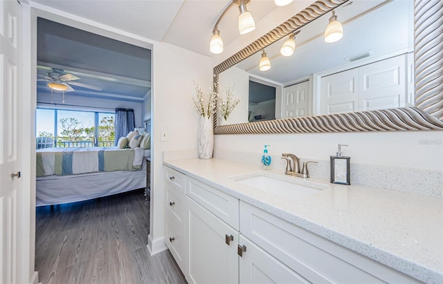 bathroom featuring vanity, hardwood / wood-style flooring, and ceiling fan