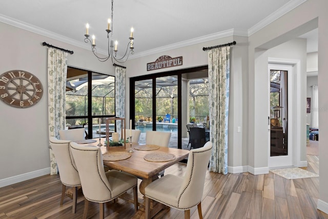 dining room featuring hardwood / wood-style flooring, ornamental molding, and plenty of natural light