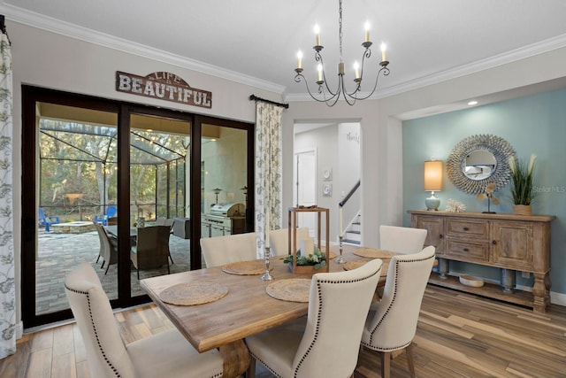 dining room with an inviting chandelier, hardwood / wood-style floors, and ornamental molding