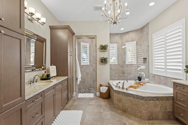 bathroom with vanity, separate shower and tub, and a notable chandelier