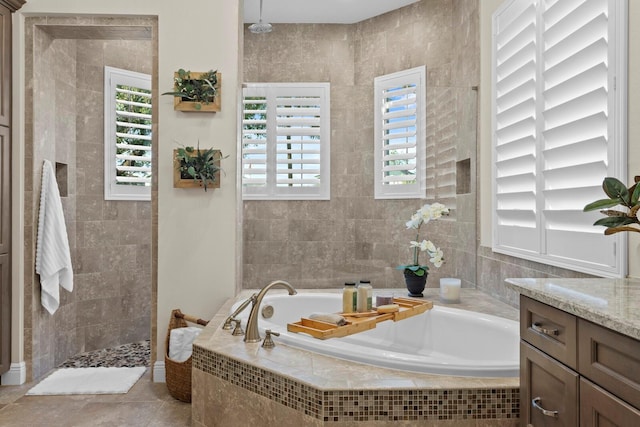 bathroom featuring vanity, independent shower and bath, and tile walls