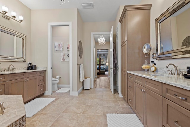 bathroom with vanity, tile patterned floors, and toilet