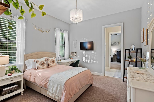 carpeted bedroom with a notable chandelier