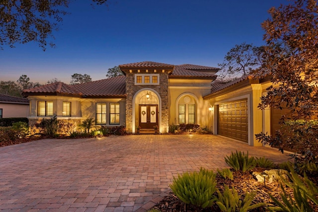 mediterranean / spanish home featuring a garage