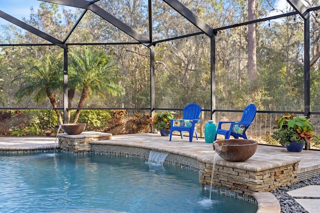 view of pool featuring pool water feature, a patio, and glass enclosure