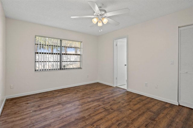 unfurnished room with ceiling fan, dark hardwood / wood-style floors, and a textured ceiling