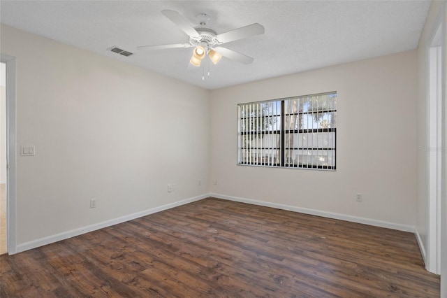 empty room featuring dark hardwood / wood-style floors, a textured ceiling, and ceiling fan