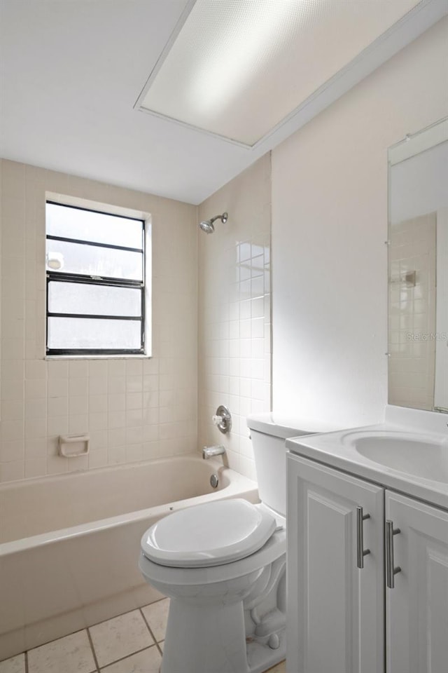 full bathroom with vanity, toilet, tiled shower / bath combo, and tile patterned flooring