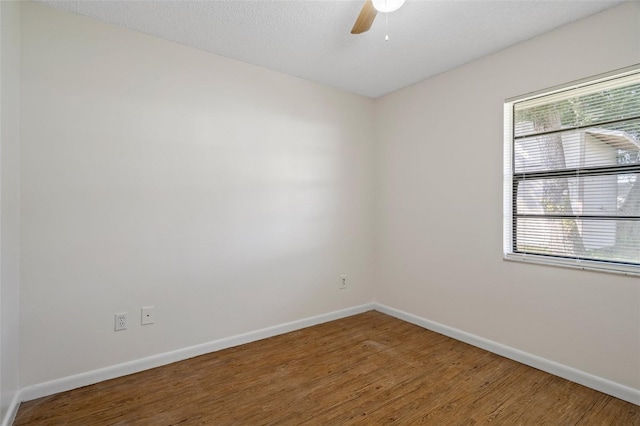 unfurnished room featuring hardwood / wood-style flooring, ceiling fan, and a textured ceiling