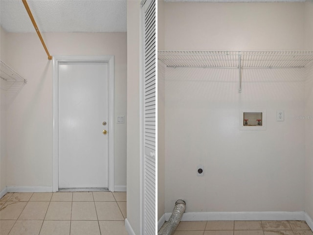 laundry room with hookup for an electric dryer, hookup for a washing machine, a textured ceiling, and light tile patterned floors