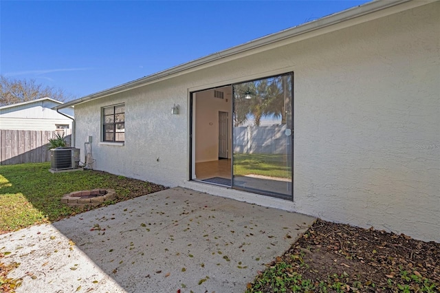 doorway to property with a patio and central AC unit