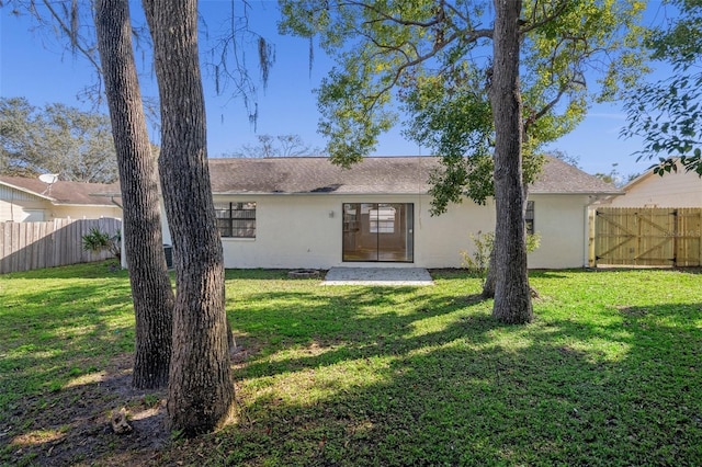 rear view of property with a yard