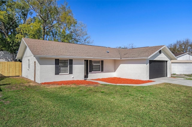 single story home with a garage and a front lawn