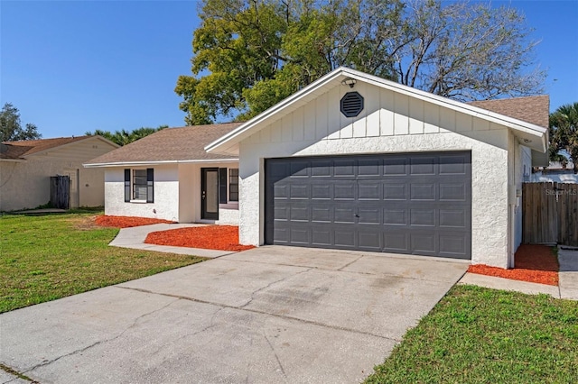 single story home featuring a garage and a front lawn