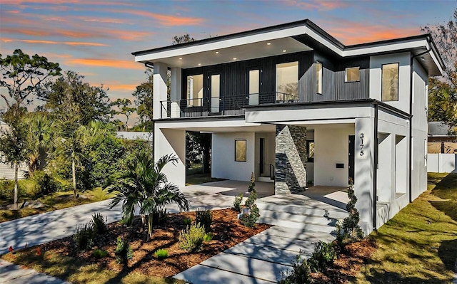 modern home with a garage and a balcony