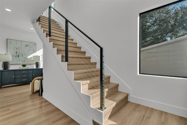 stairs with hardwood / wood-style flooring