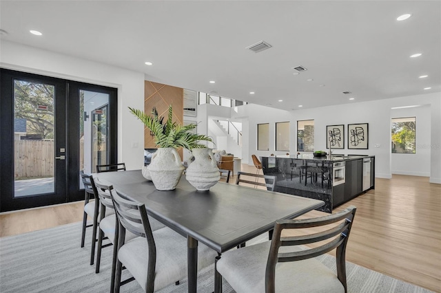 dining space featuring sink and light wood-type flooring