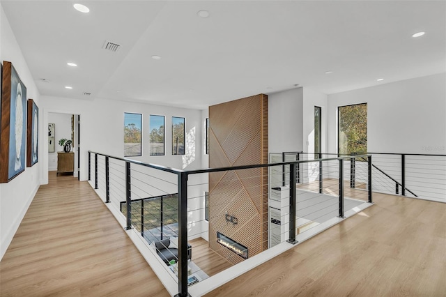 corridor with light hardwood / wood-style flooring