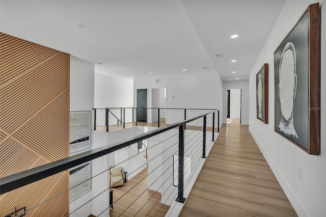 hallway with light hardwood / wood-style floors