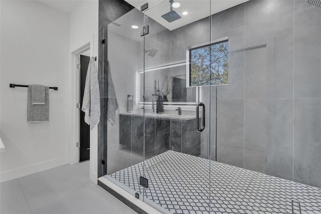 bathroom with an enclosed shower and tile patterned flooring