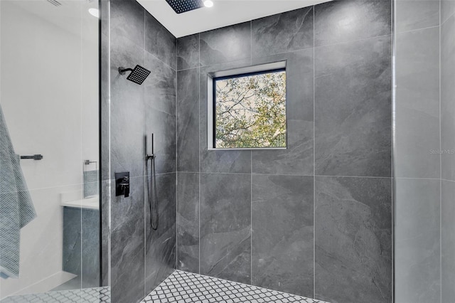 bathroom with tiled shower