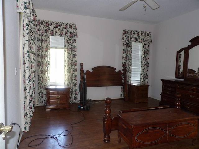 bedroom with dark wood-type flooring and ceiling fan