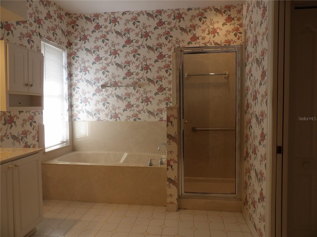 bathroom featuring vanity and separate shower and tub