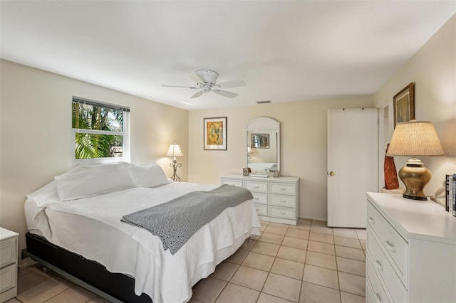 tiled bedroom featuring ceiling fan