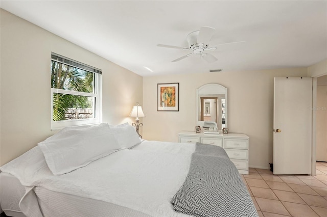 tiled bedroom with ceiling fan