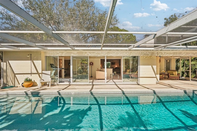 view of swimming pool with a patio area and glass enclosure