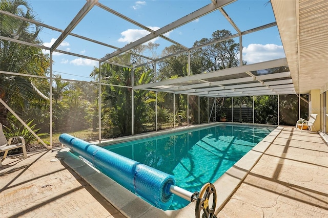 view of swimming pool with a patio area and glass enclosure