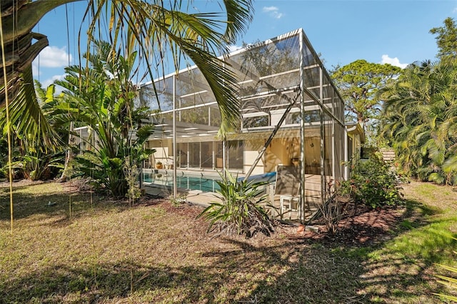 rear view of property with a lanai