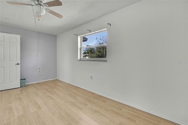 unfurnished room with a textured ceiling, ceiling fan, and light wood-type flooring