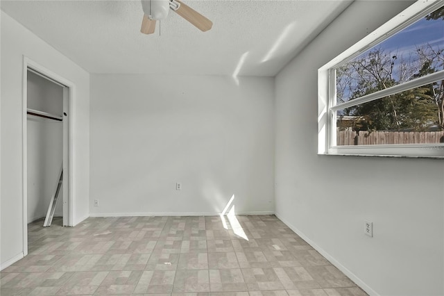 unfurnished bedroom featuring a textured ceiling and ceiling fan