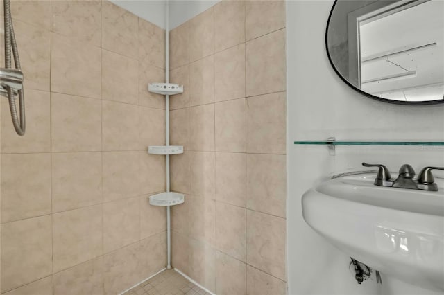 bathroom with sink and tiled shower