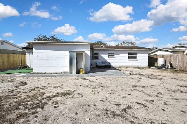 rear view of property featuring a patio