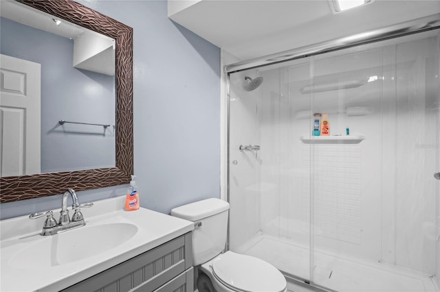 bathroom with vanity, toilet, and walk in shower