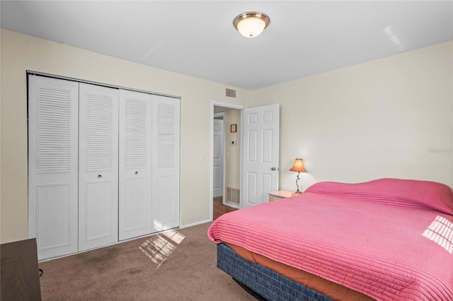 bedroom featuring a closet and dark colored carpet