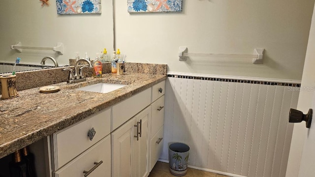bathroom featuring radiator, wainscoting, vanity, and tile patterned floors