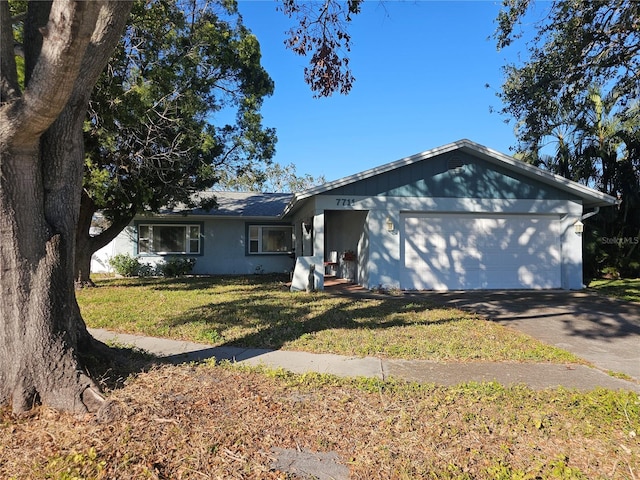 single story home with a garage, driveway, and a front lawn