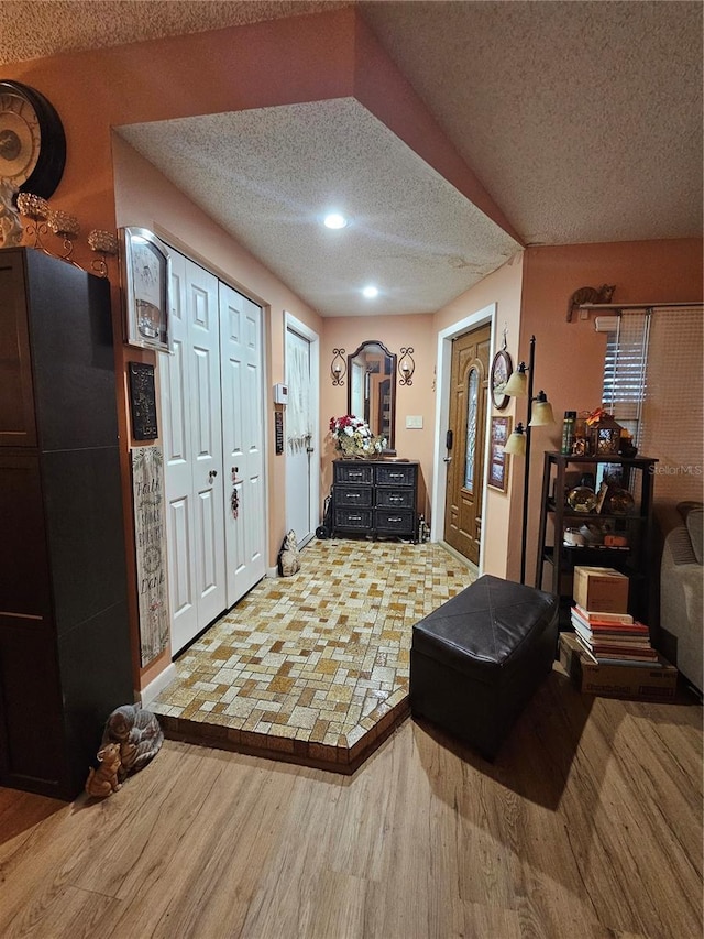 entrance foyer featuring hardwood / wood-style flooring and a textured ceiling