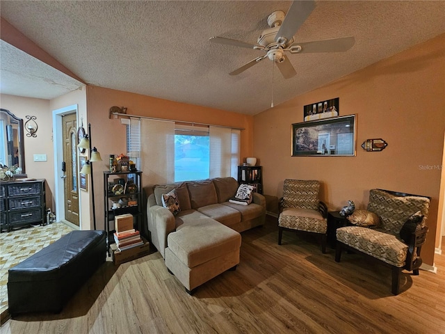 living room featuring vaulted ceiling, hardwood / wood-style floors, ceiling fan, and a textured ceiling